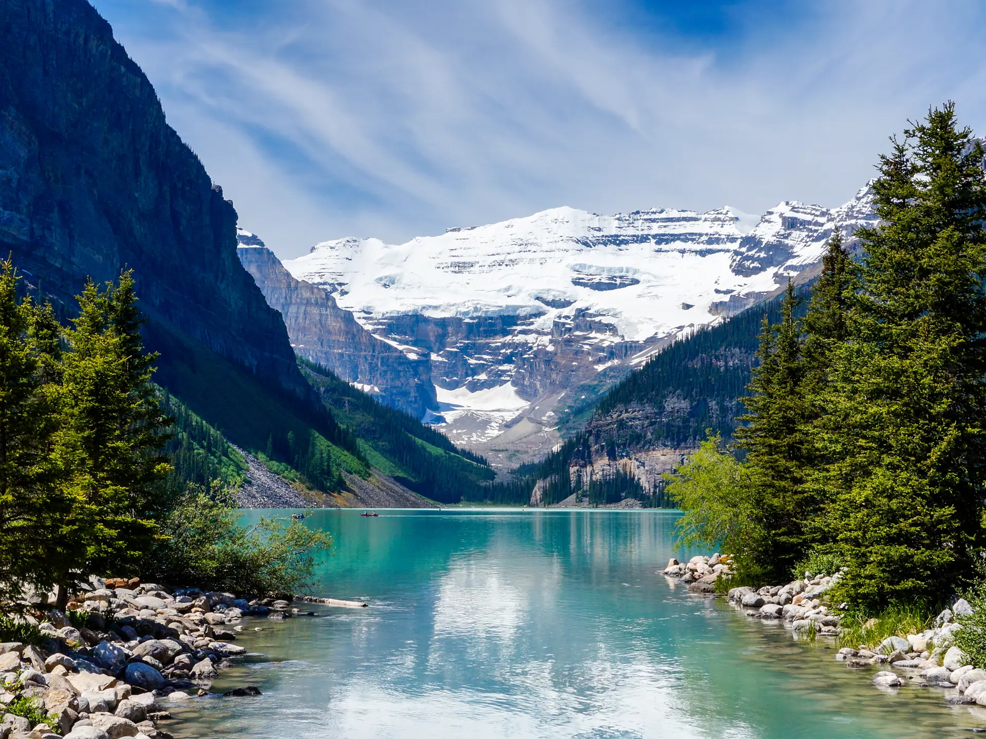 shutterstock_209238454 Beautiful Lake Louise with Victoria Glacier in the background and a glistening emerald lake. Several canoes can be seen..jpg