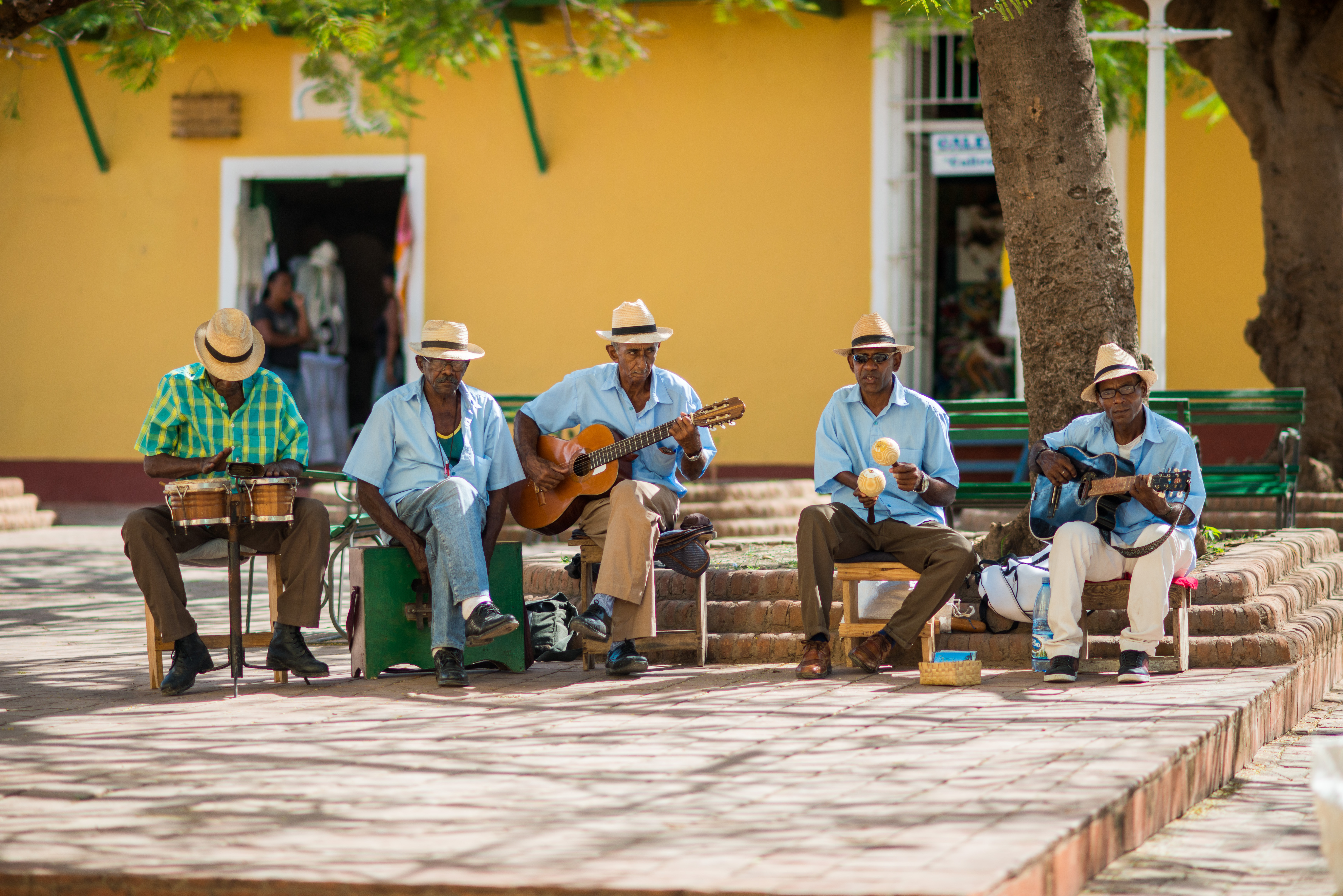 shutterstock_512230474 TRINIDAD, CUBA - APRIL 06, 2014 Group of Latino American men of musicians play on maracases, guitar and small drums a.jpg