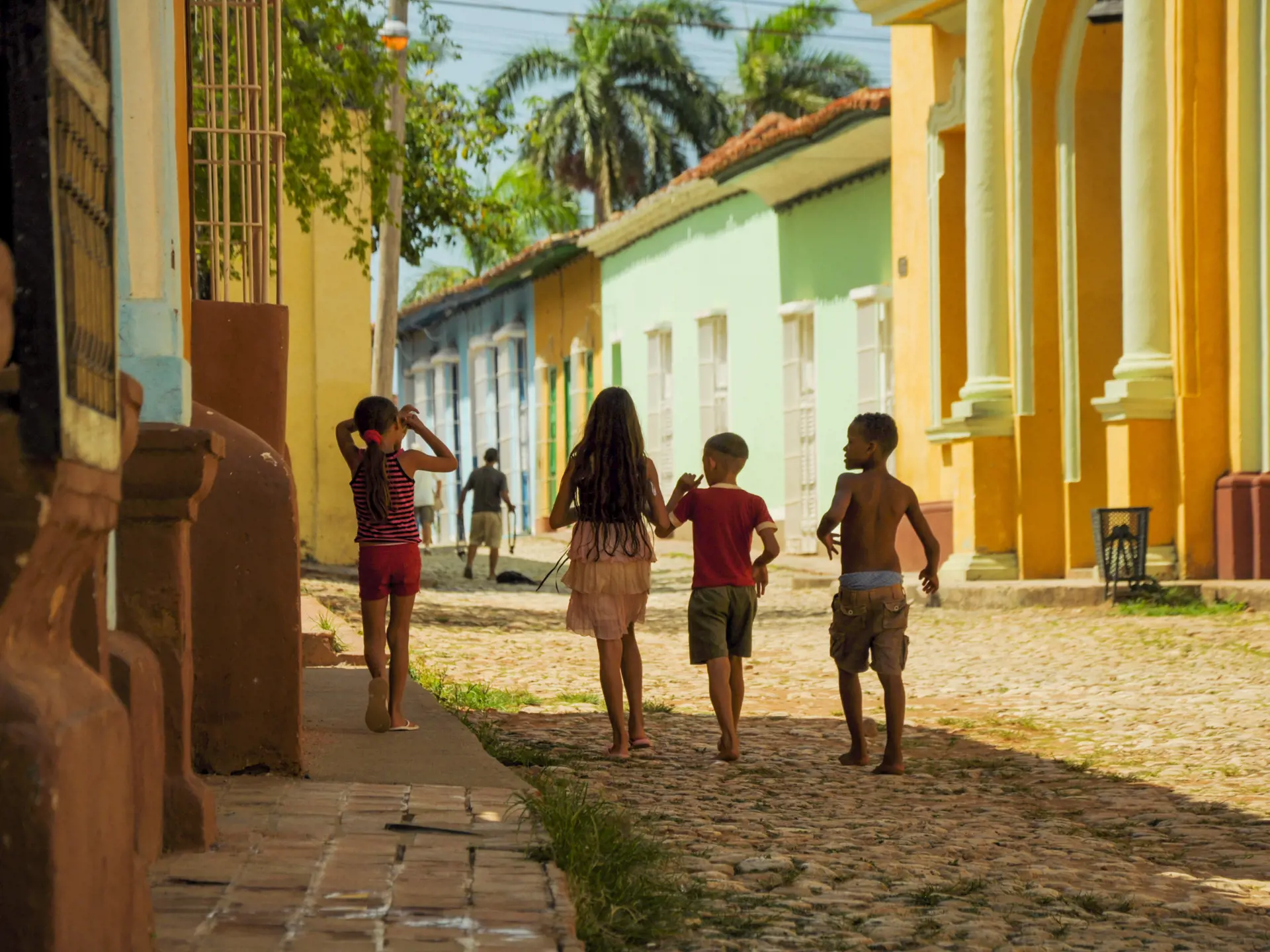 TRINIDAD, CUBA - MAY 26, 2013  kids walking on the street in UNESCO protected city of Trinidad, Cuba..jpg