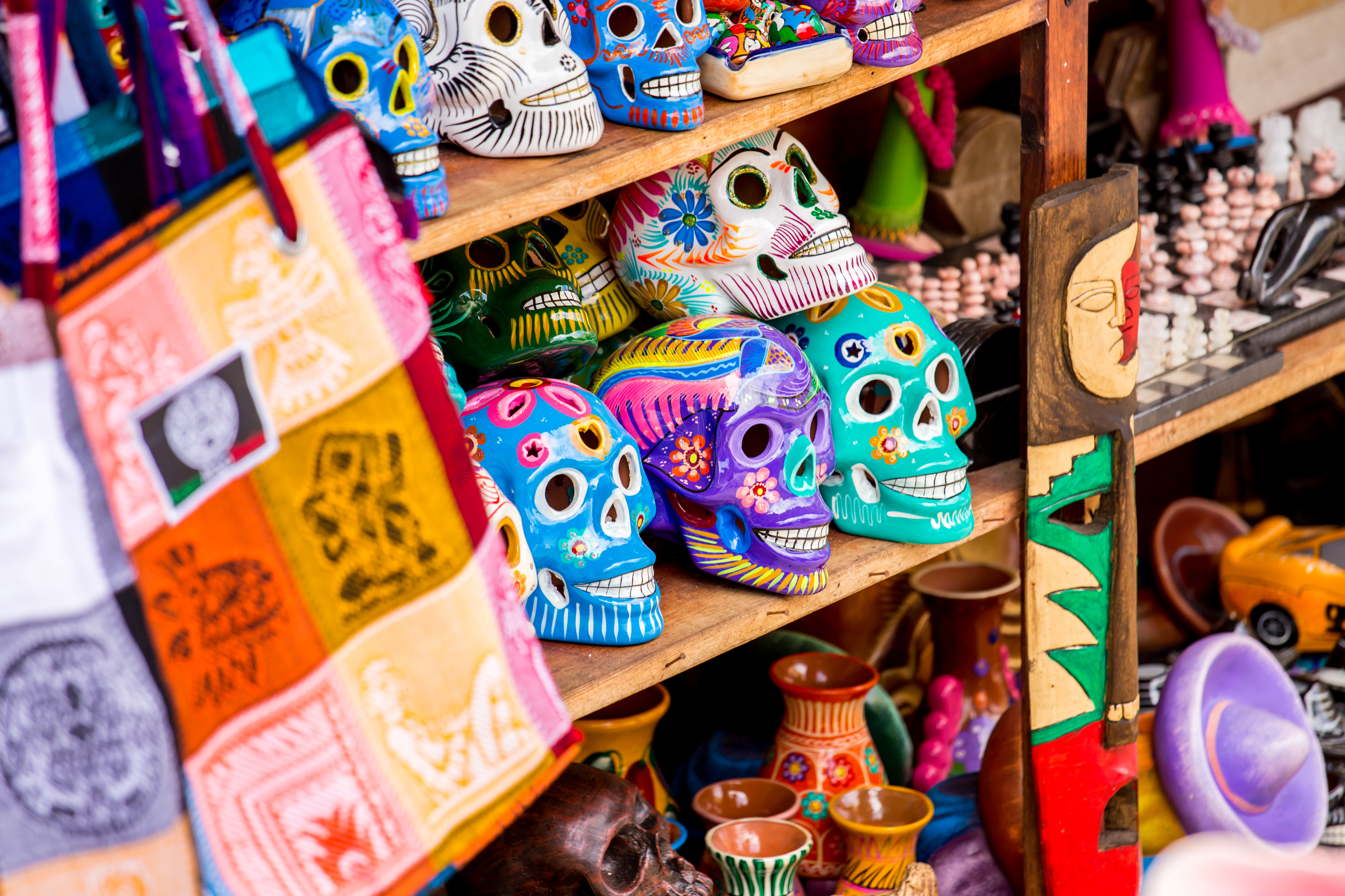 shutterstock_190028570 Colorful skulls souvenirs in Playa del Carmen, Mexico.jpg