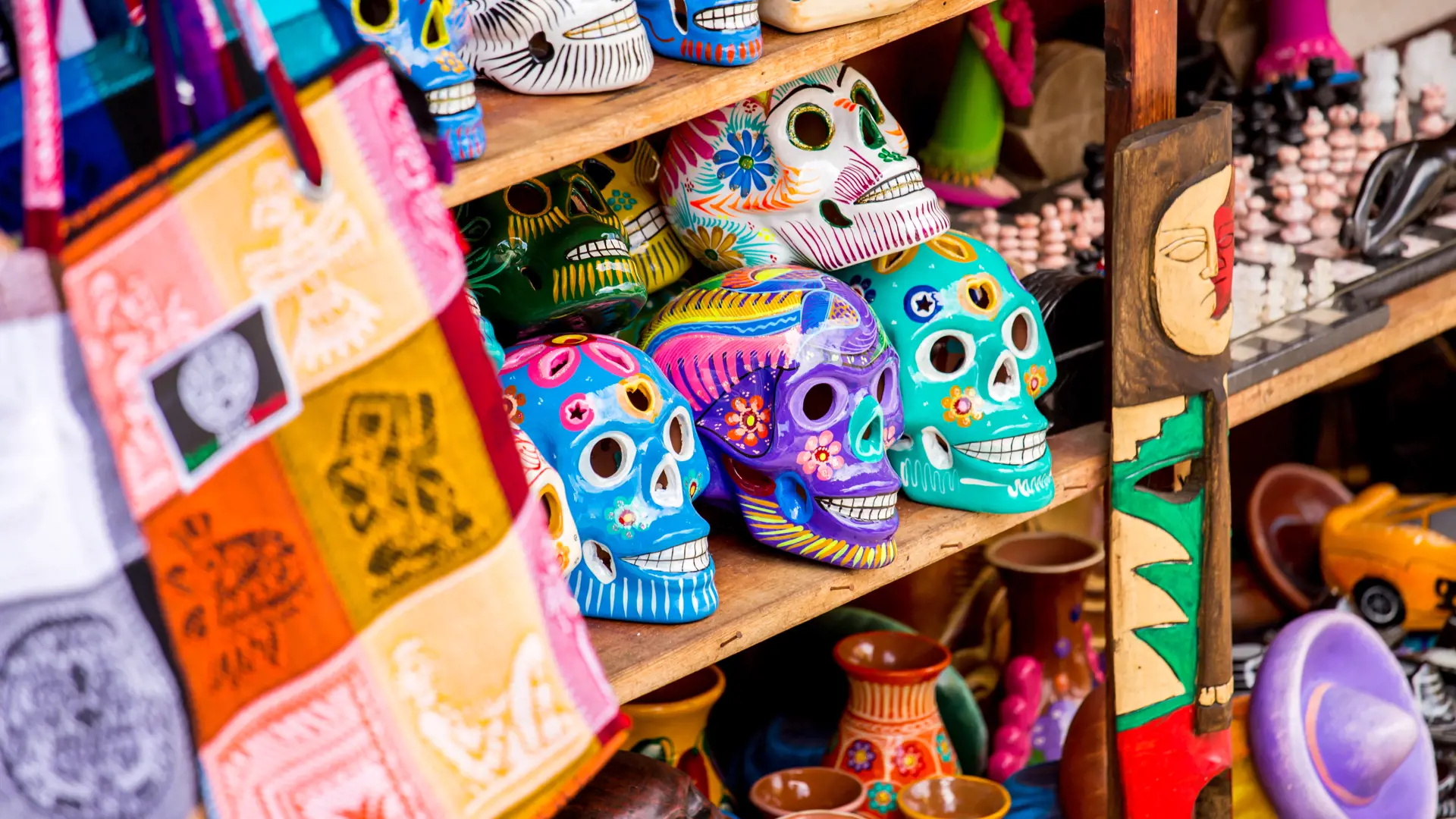 shutterstock_190028570 Colorful skulls souvenirs in Playa del Carmen, Mexico.jpg