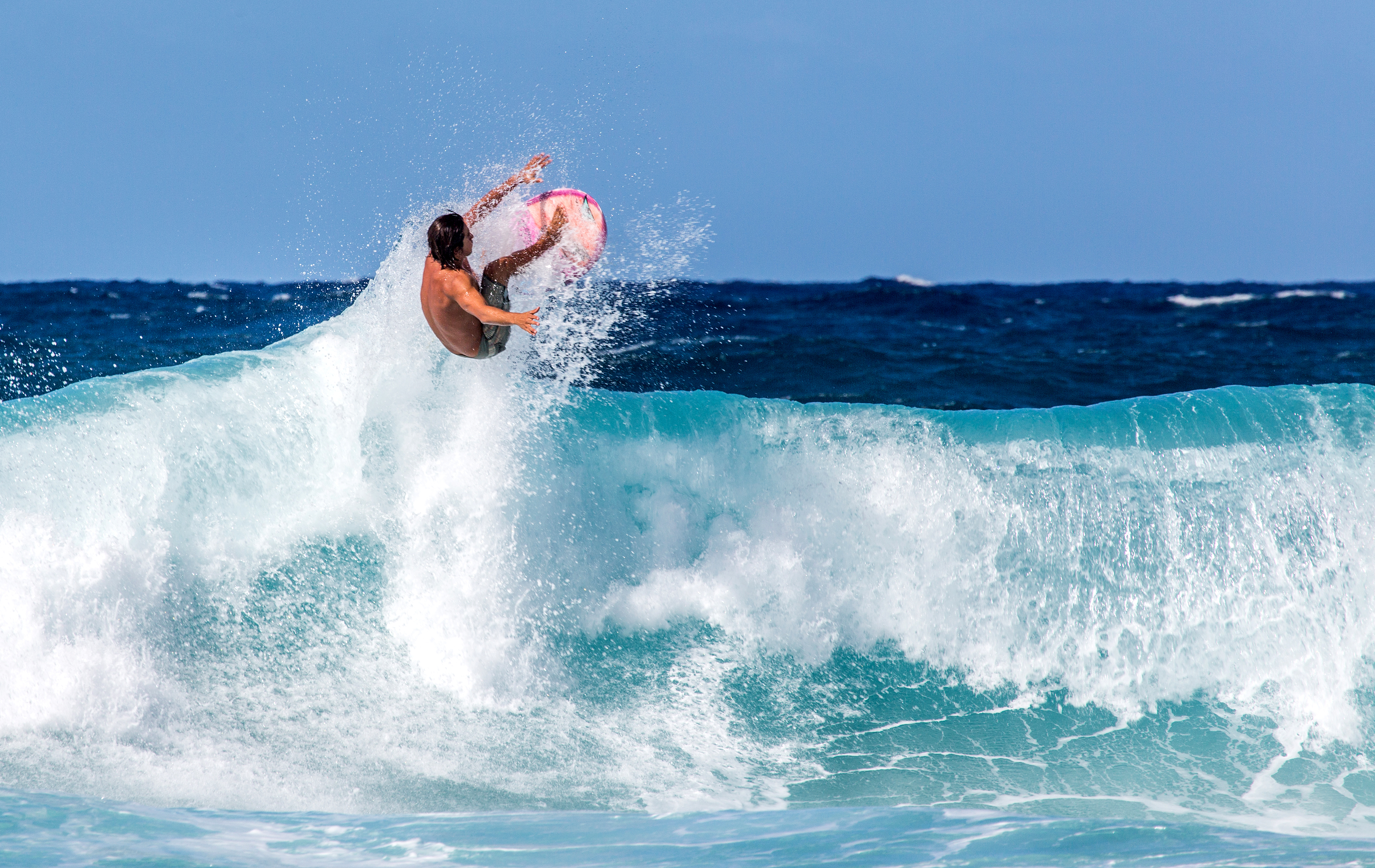 Surfer jumping above a wave on the North Shore of Oahu, Hawaii.jpg