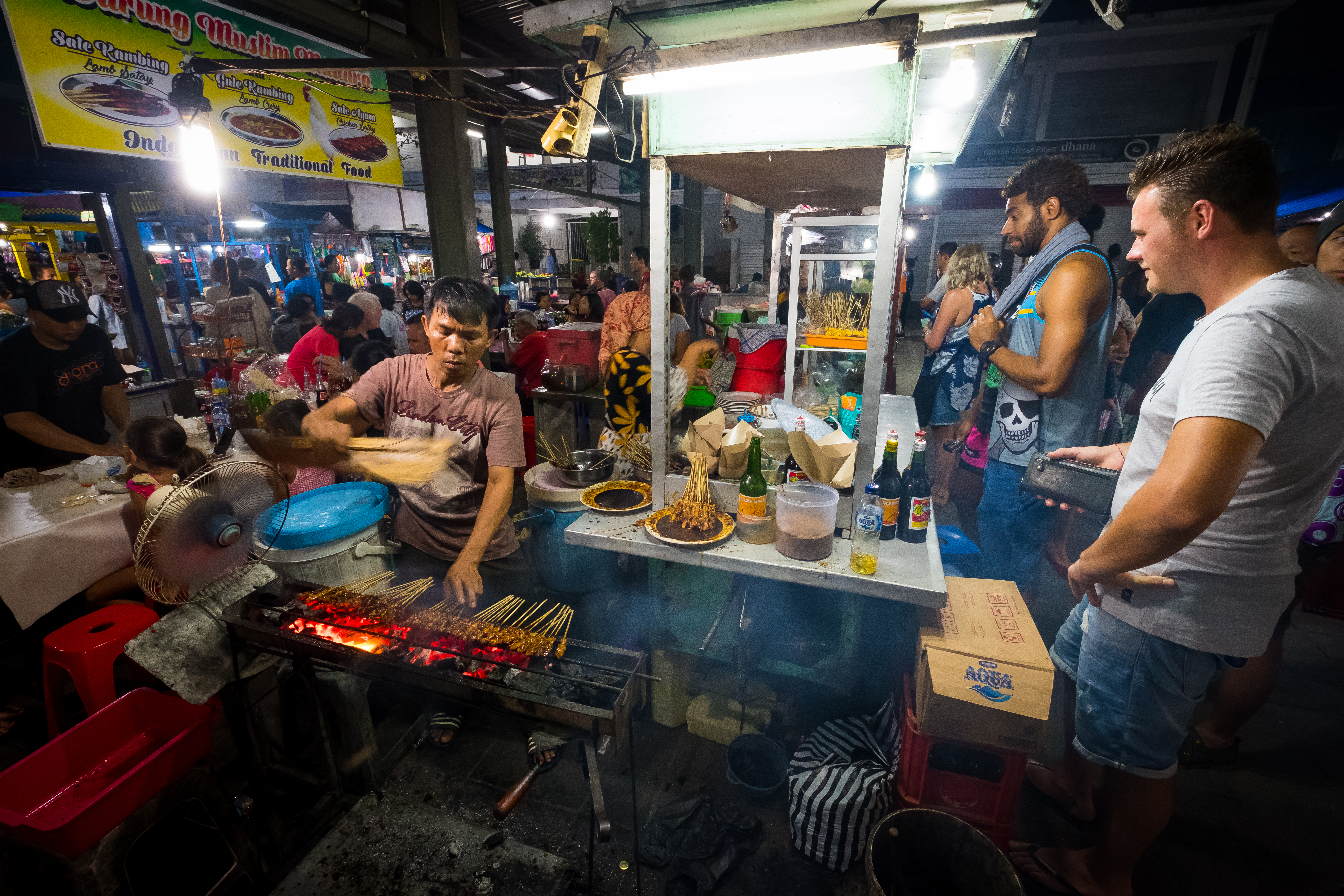 Sanur, Bali  Indonesia - December 28 2017 Scene of a worker at the local night market with customer surrounding.jpg (1)