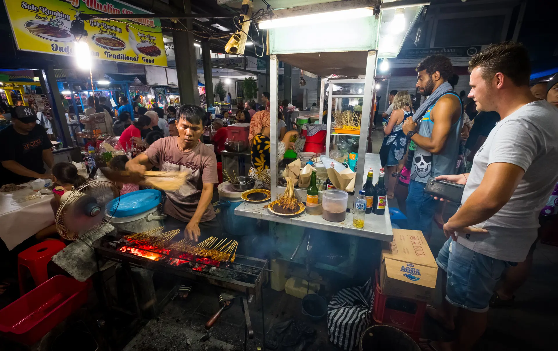 Sanur, Bali  Indonesia - December 28 2017 Scene of a worker at the local night market with customer surrounding.jpg (1)