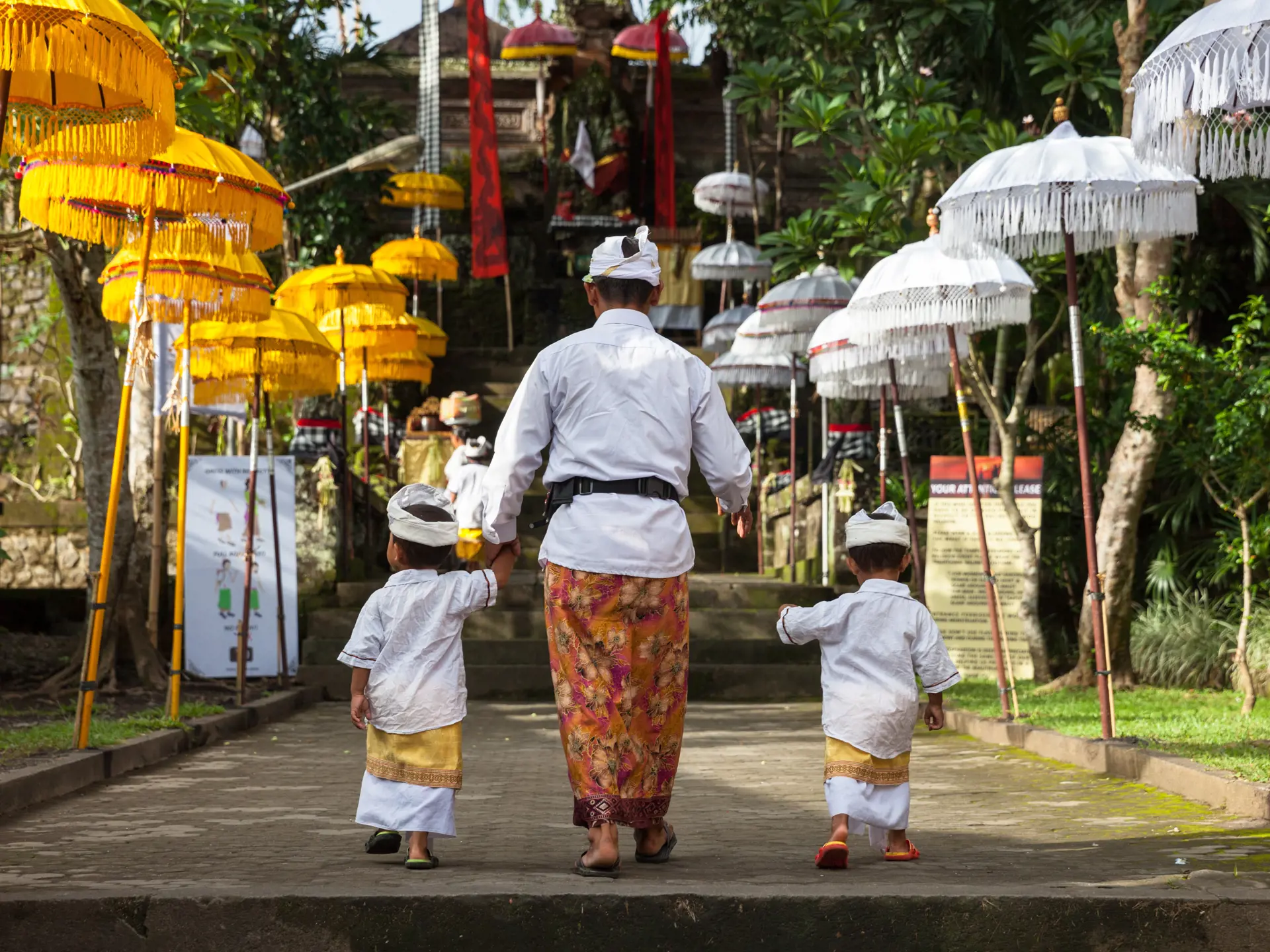 UBUD, INDONESIA - MARCH 2 Man with children walks up the stairs during the celebration before Nyepi (Balinese Day of Silence).jpg