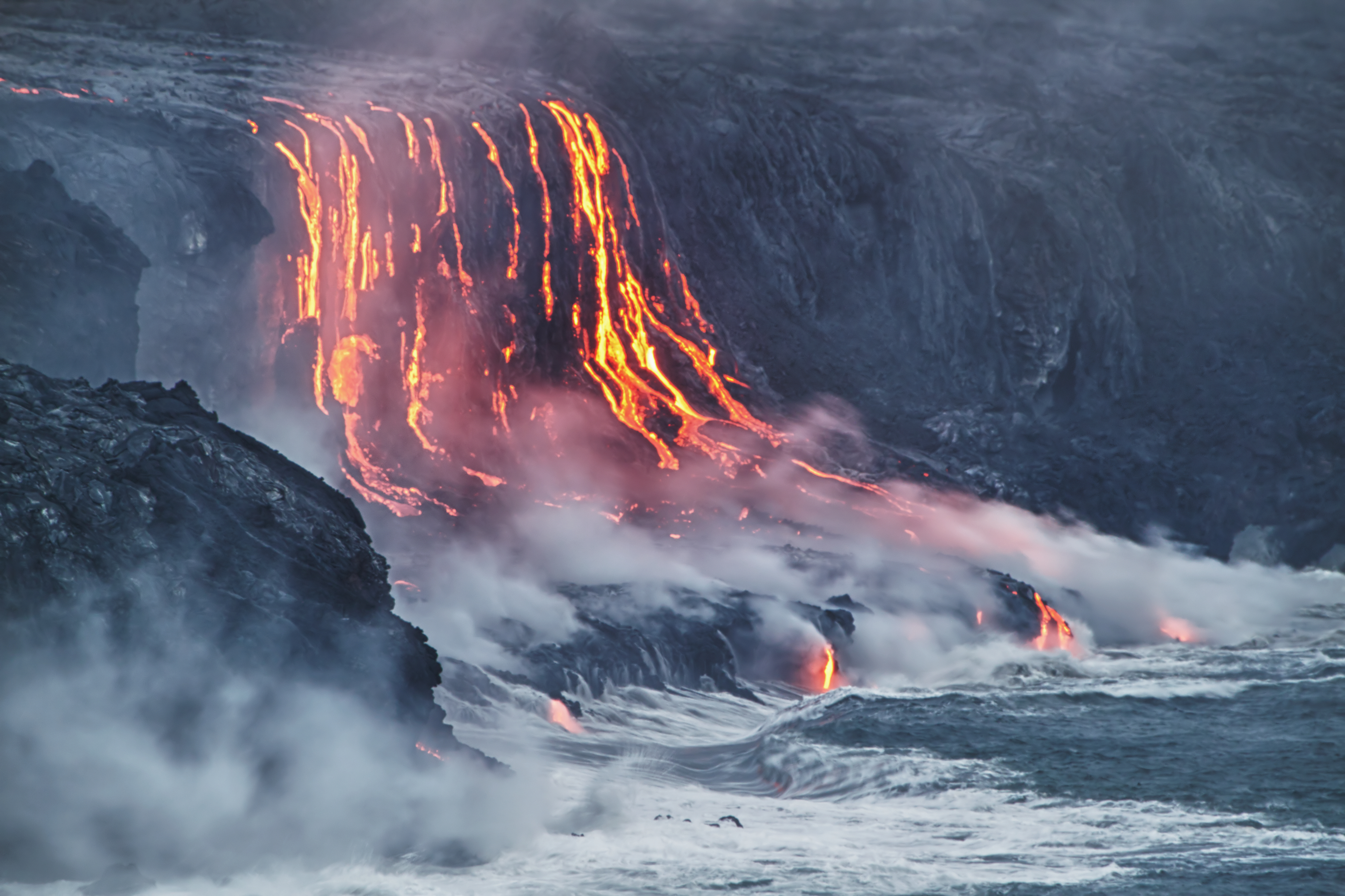 shutterstock_102905030 Lava erupting into Pacific Ocean in Hawaii Big Island.jpg
