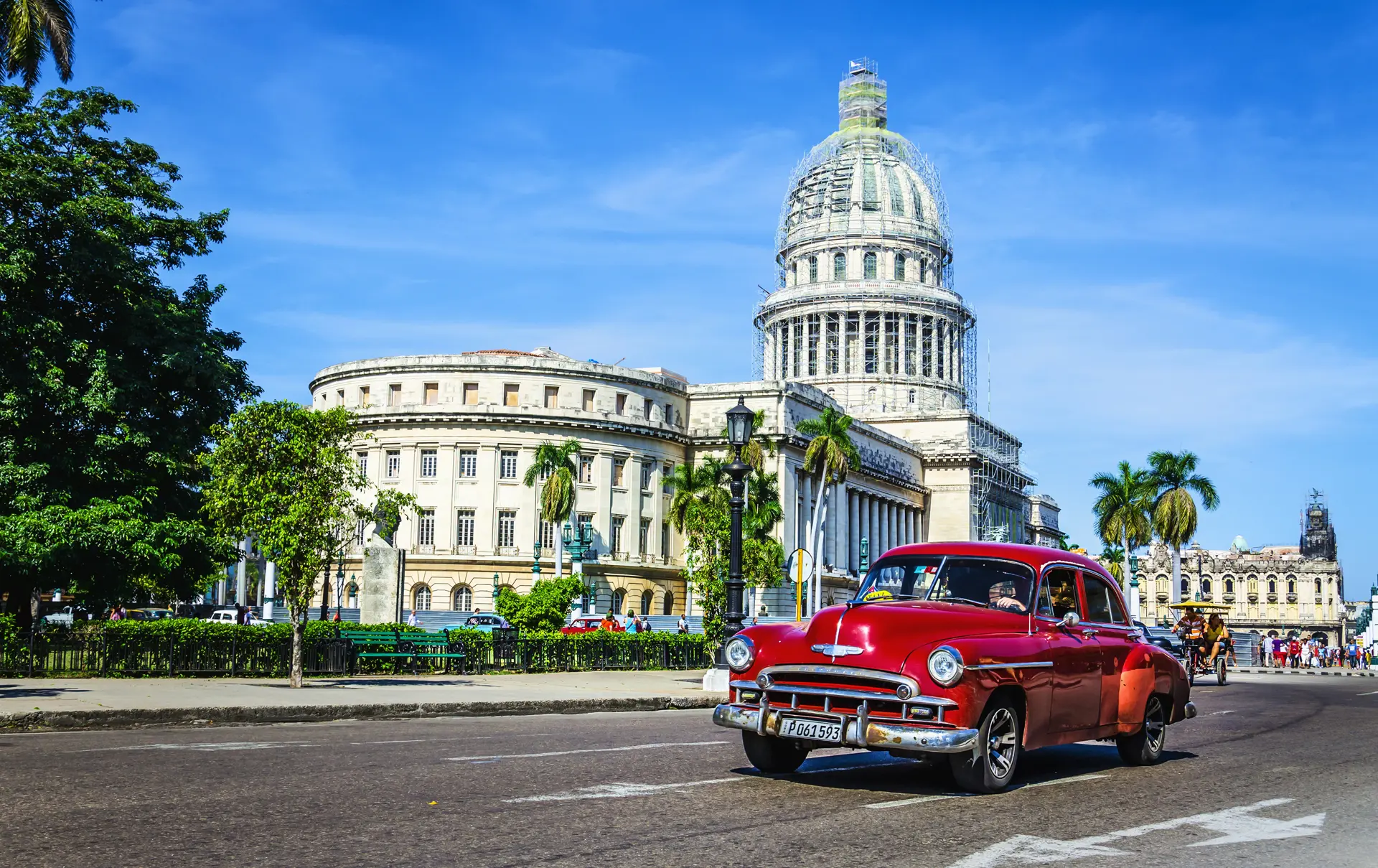 shutterstock_204192301  Old classic American maroon car rides in front of the Capitol.jpg