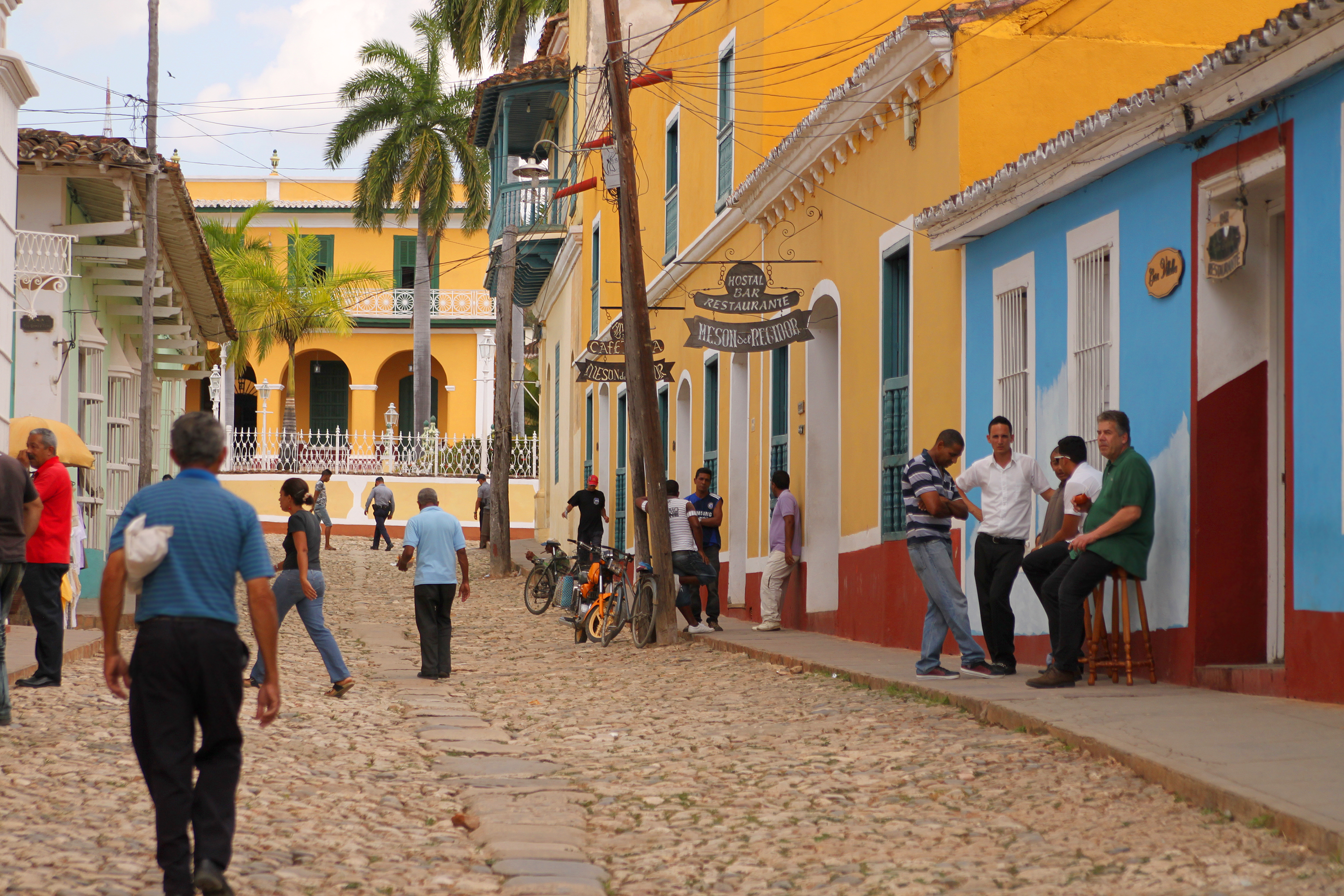 shutterstock_182426093 Cuban people hanging out and crossing the cobblestone street in Trinidad, Cuba.jpg