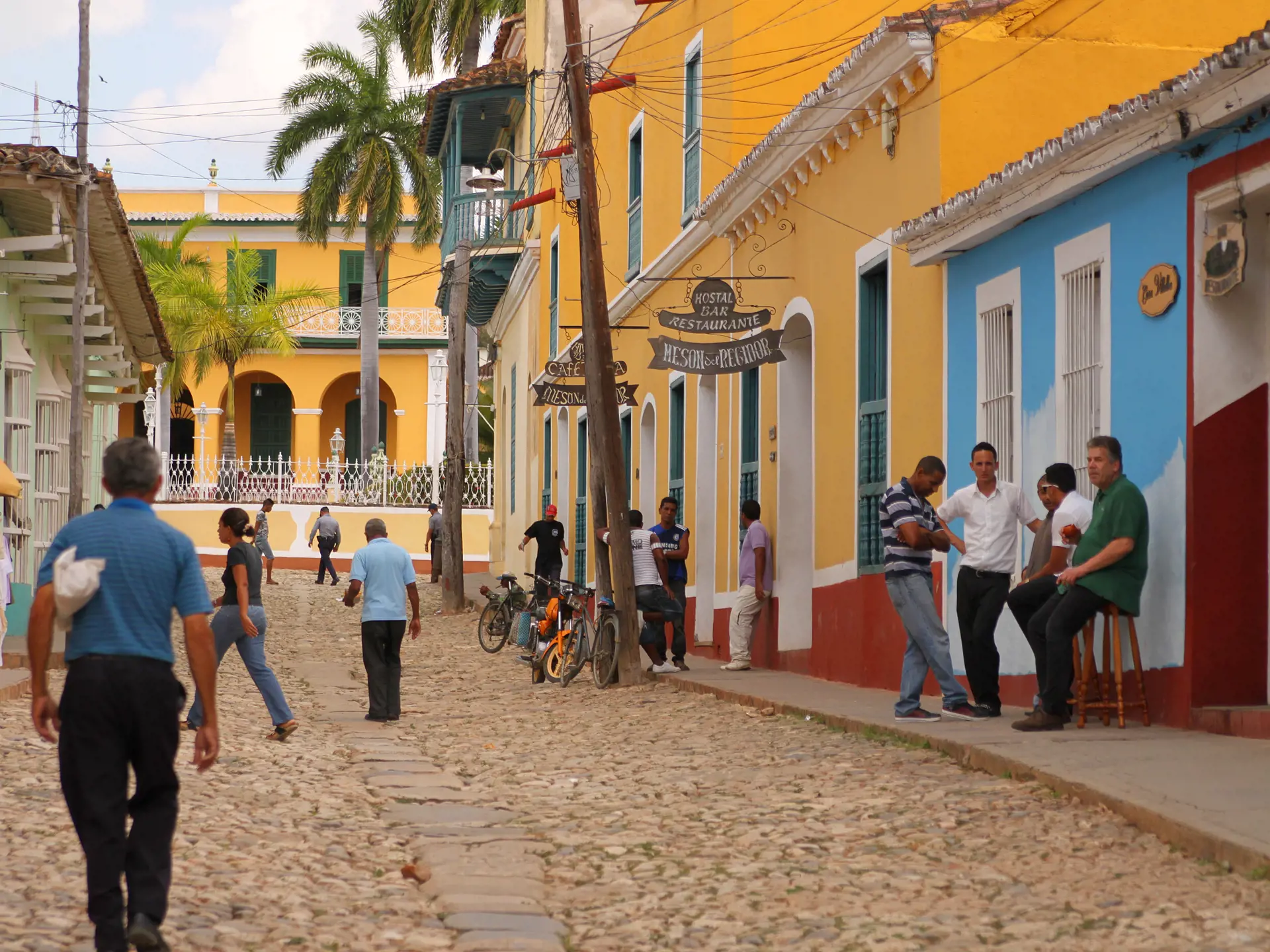 shutterstock_182426093 Cuban people hanging out and crossing the cobblestone street in Trinidad, Cuba.jpg