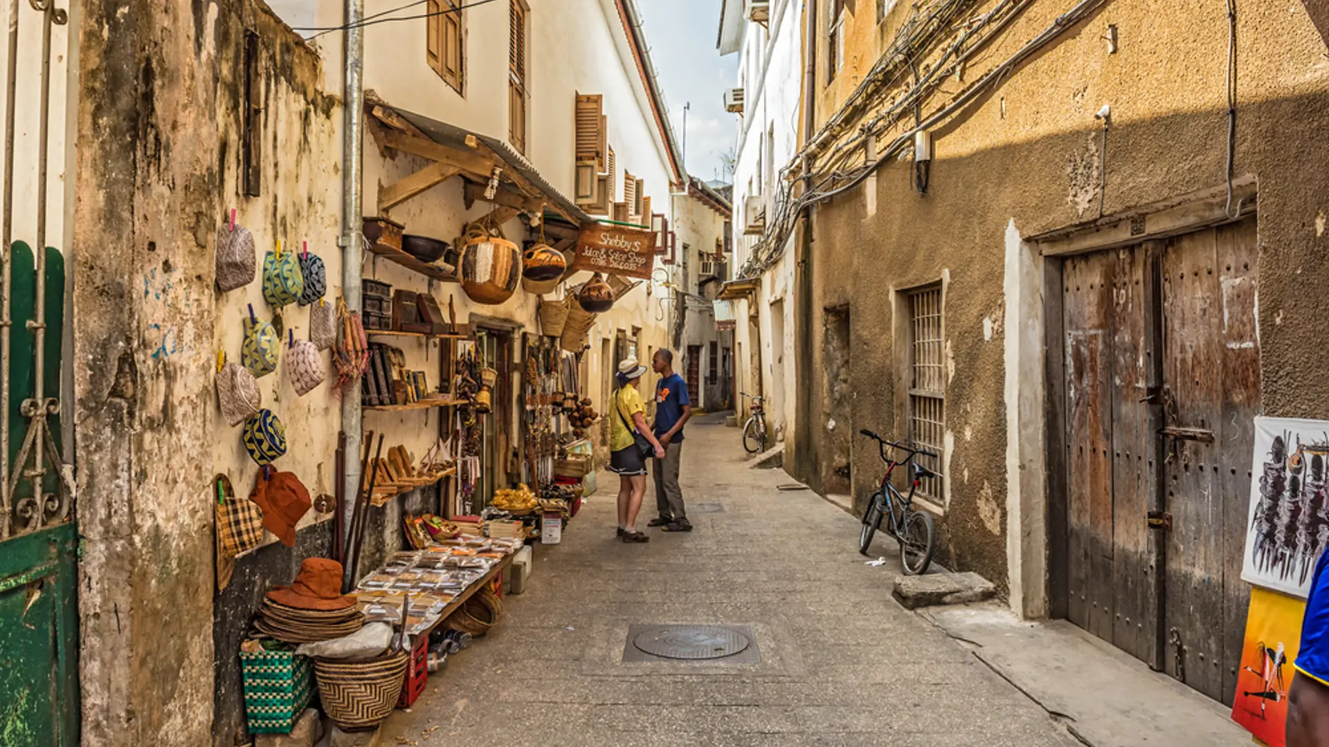 Tourists On A Typical Narrow Street In Stone Town.