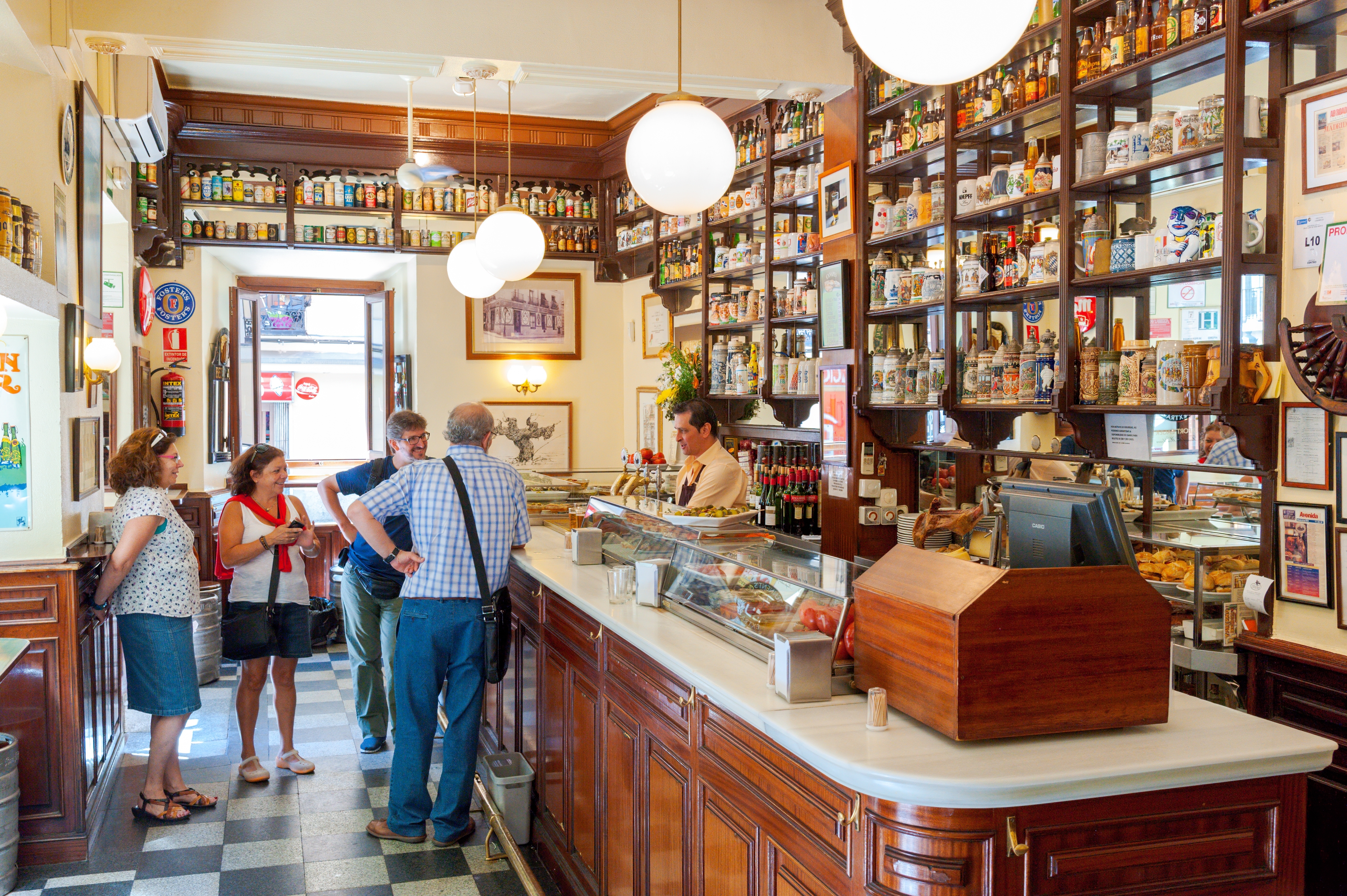 Shutterstock 2295547857 Madrid, Spain June 4, 2012 People Socialising In A Bar In The Barrio De Las Letras