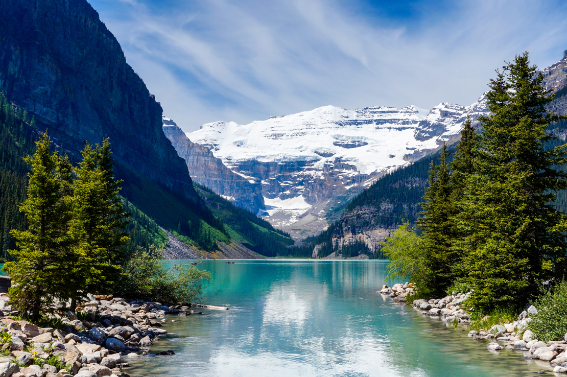 shutterstock_209238454 Beautiful Lake Louise with Victoria Glacier in the background and a glistening emerald lake. Several canoes can be seen..jpg