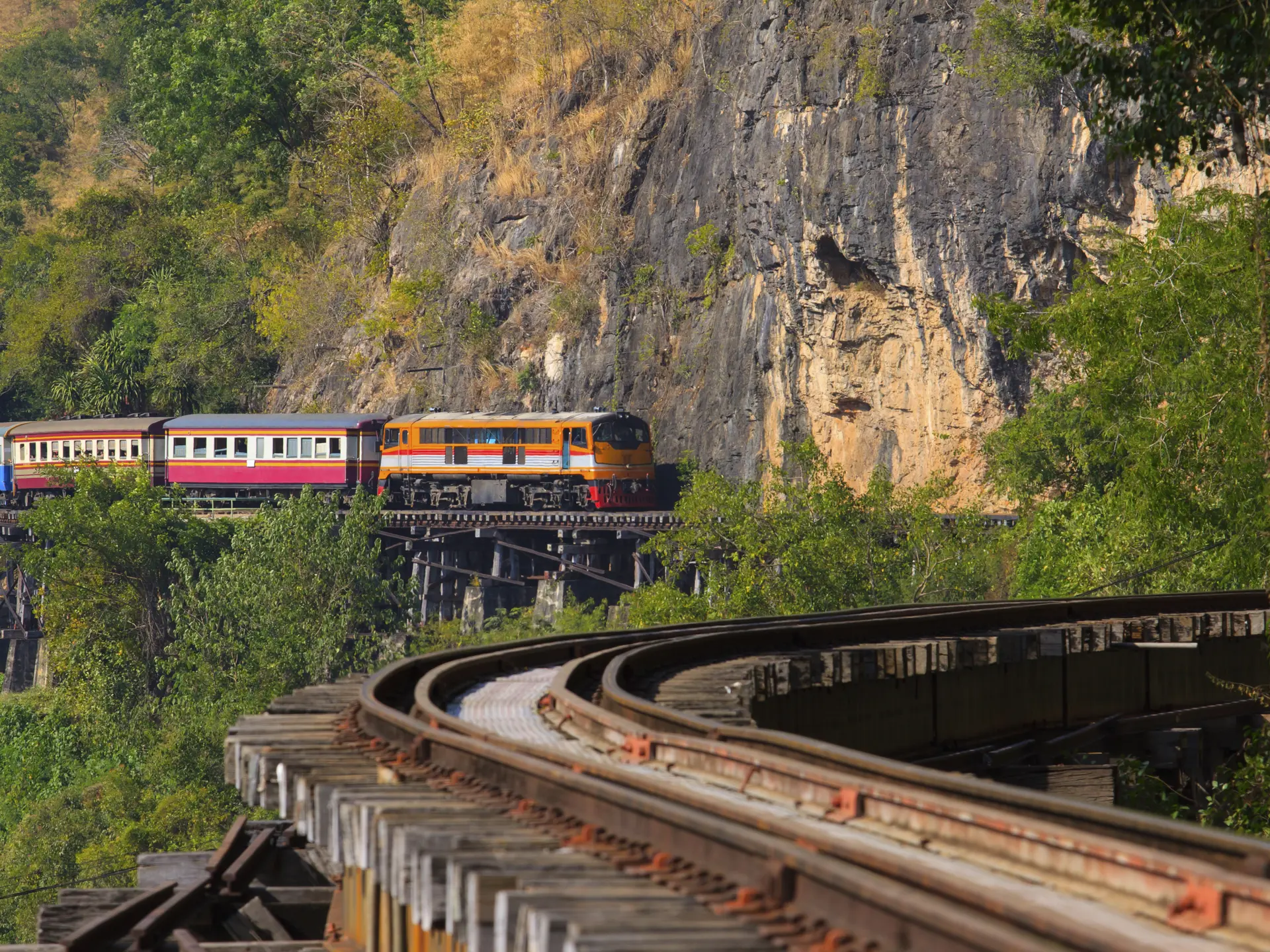 shutterstock_239065714 trains running on death railways crossing kwai river in kanchanaburi border of thailand-myanmar important landmark.jpg