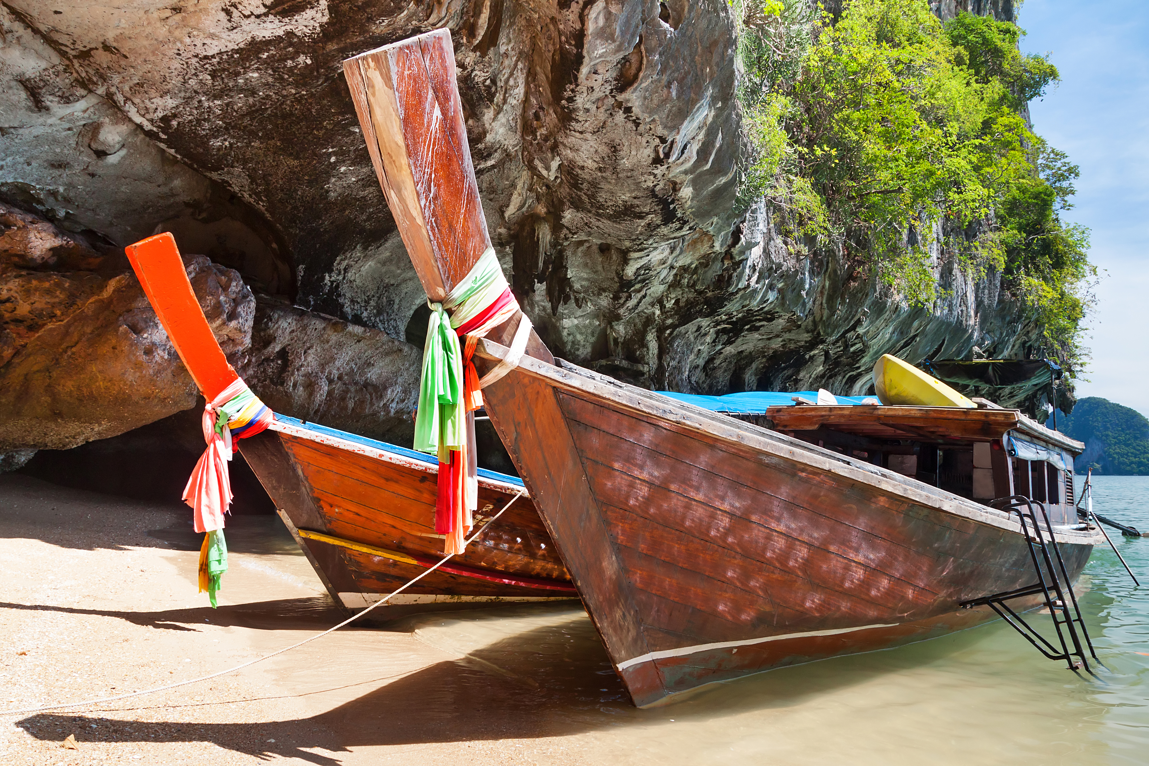 shutterstock_126168743 Thai long tail boats on the coast of Phang Nga Bay.jpg