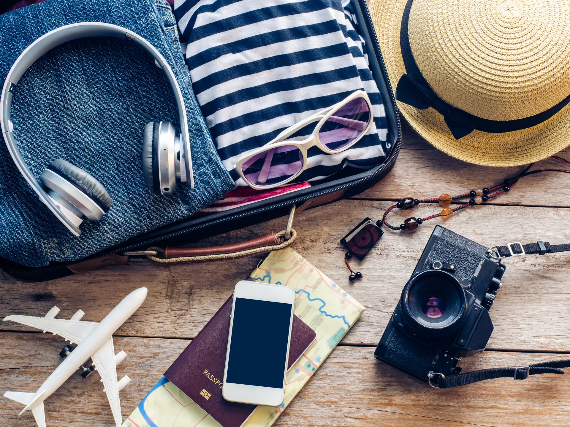 shutterstock_374838787 Clothing traveler's Passport, wallet, glasses, smart phone devices, on a wooden floor..jpg