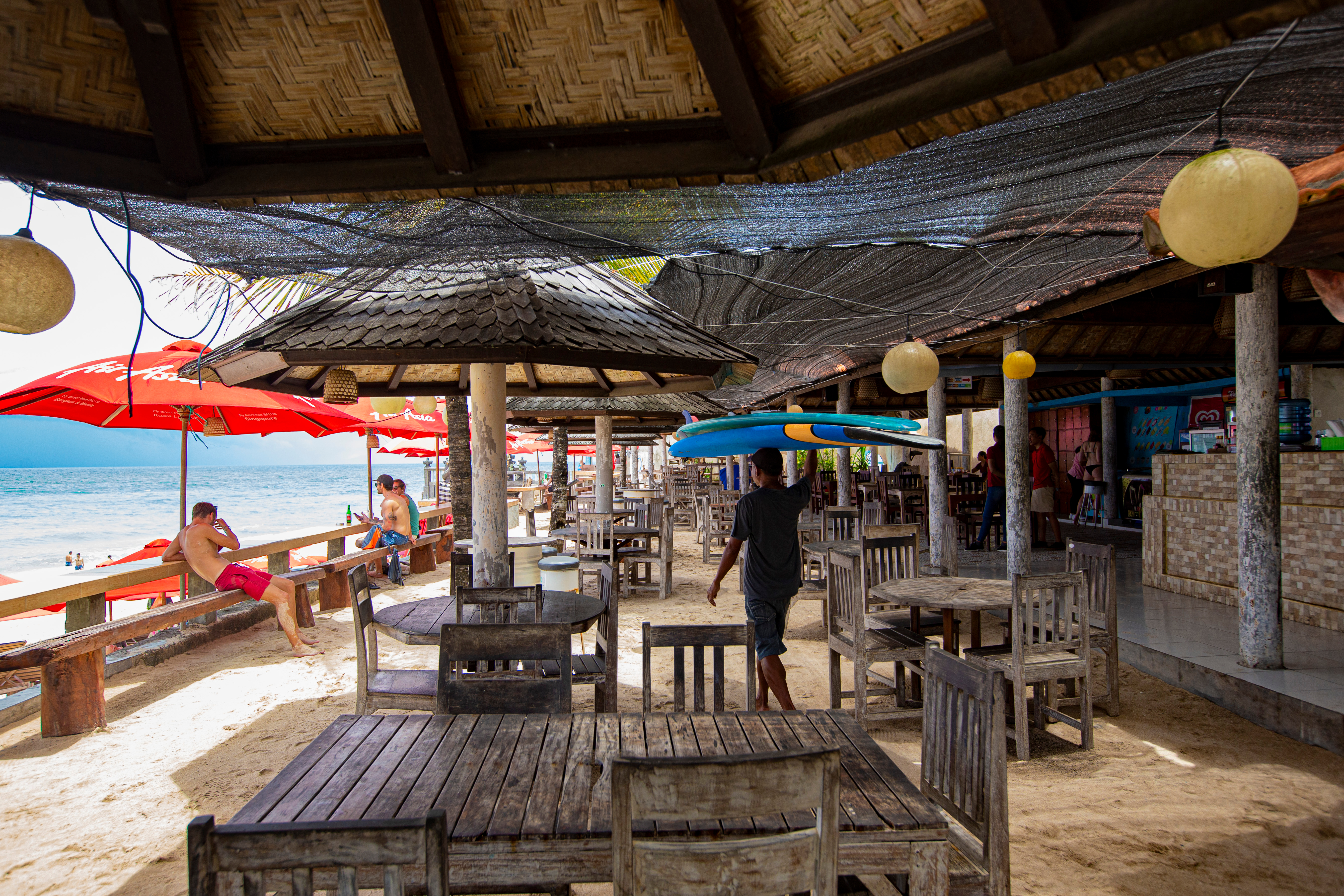 Shutterstock 1766738615 (BALI, INDONESIA February 2020 Sea View Beach Cafe With Wooden Furniture And Umbrellas On Dreamland Beach, Bali, Indonesia)