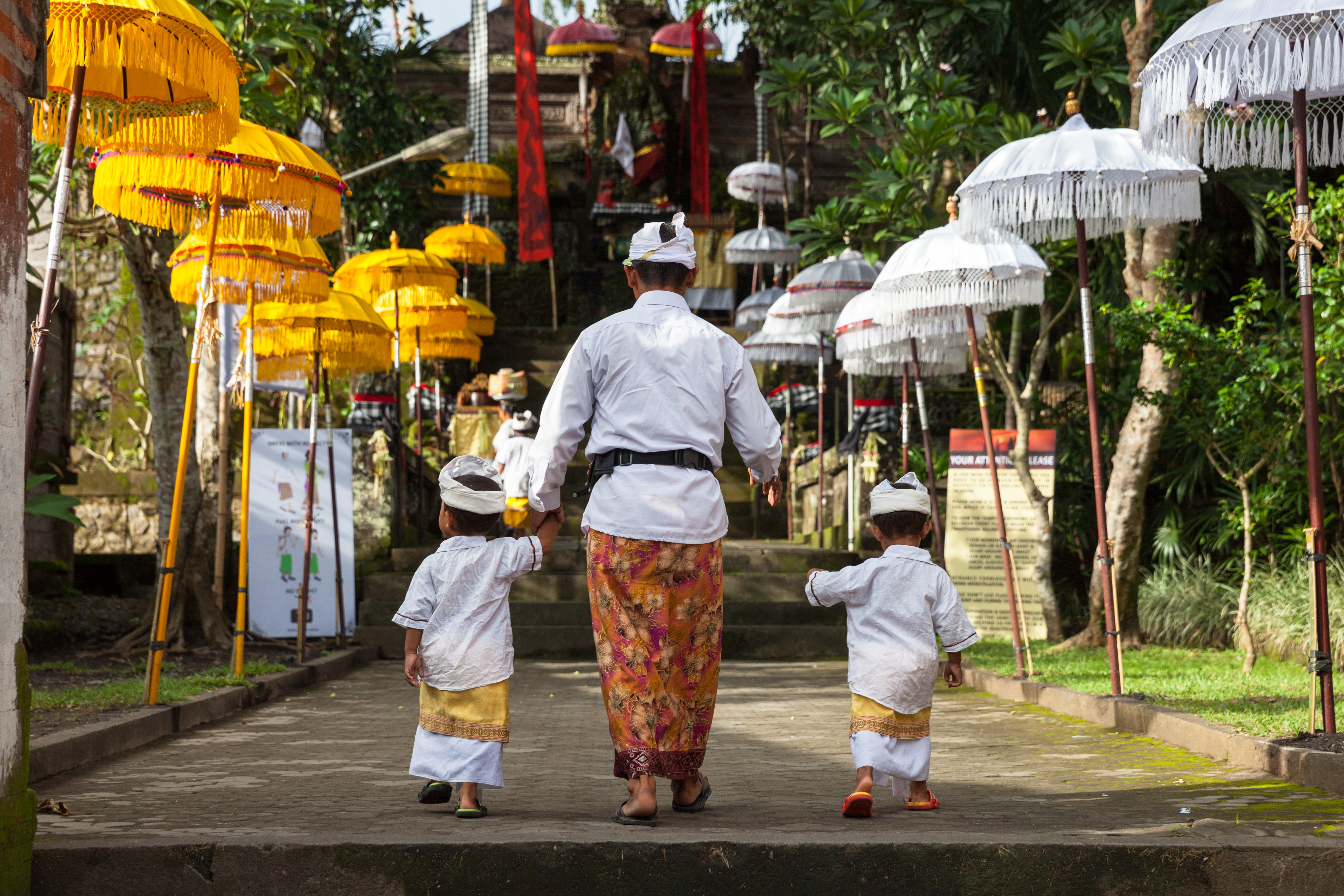 UBUD, INDONESIA MARCH 2 Man With Children Walks Up The Stairs During The Celebration Before Nyepi (Balinese Day Of Silence)