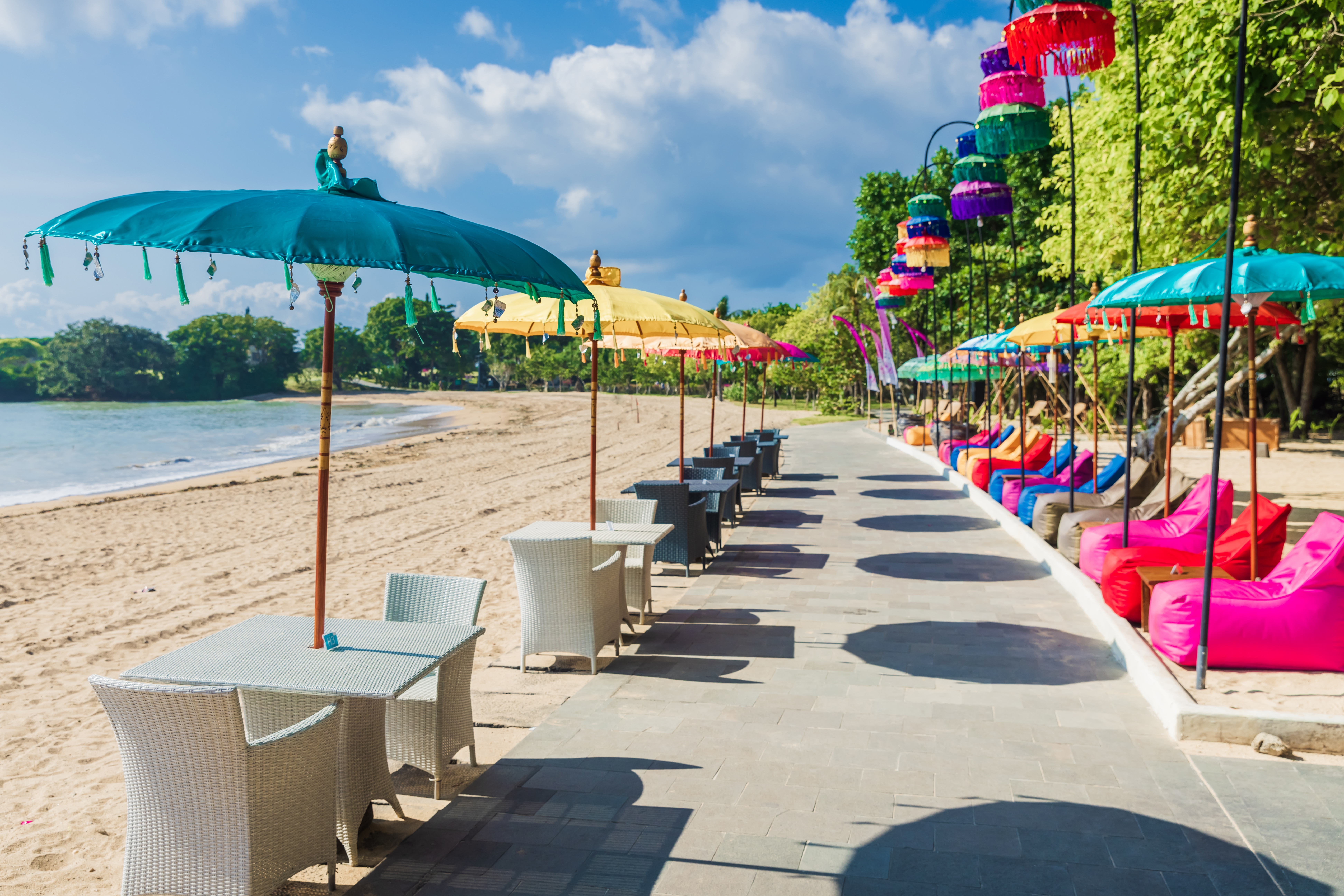 Shutterstock 2311679775 (Cafe With Colorful Umbrellas At Tropical Beach In Bali, Nusa Dua)