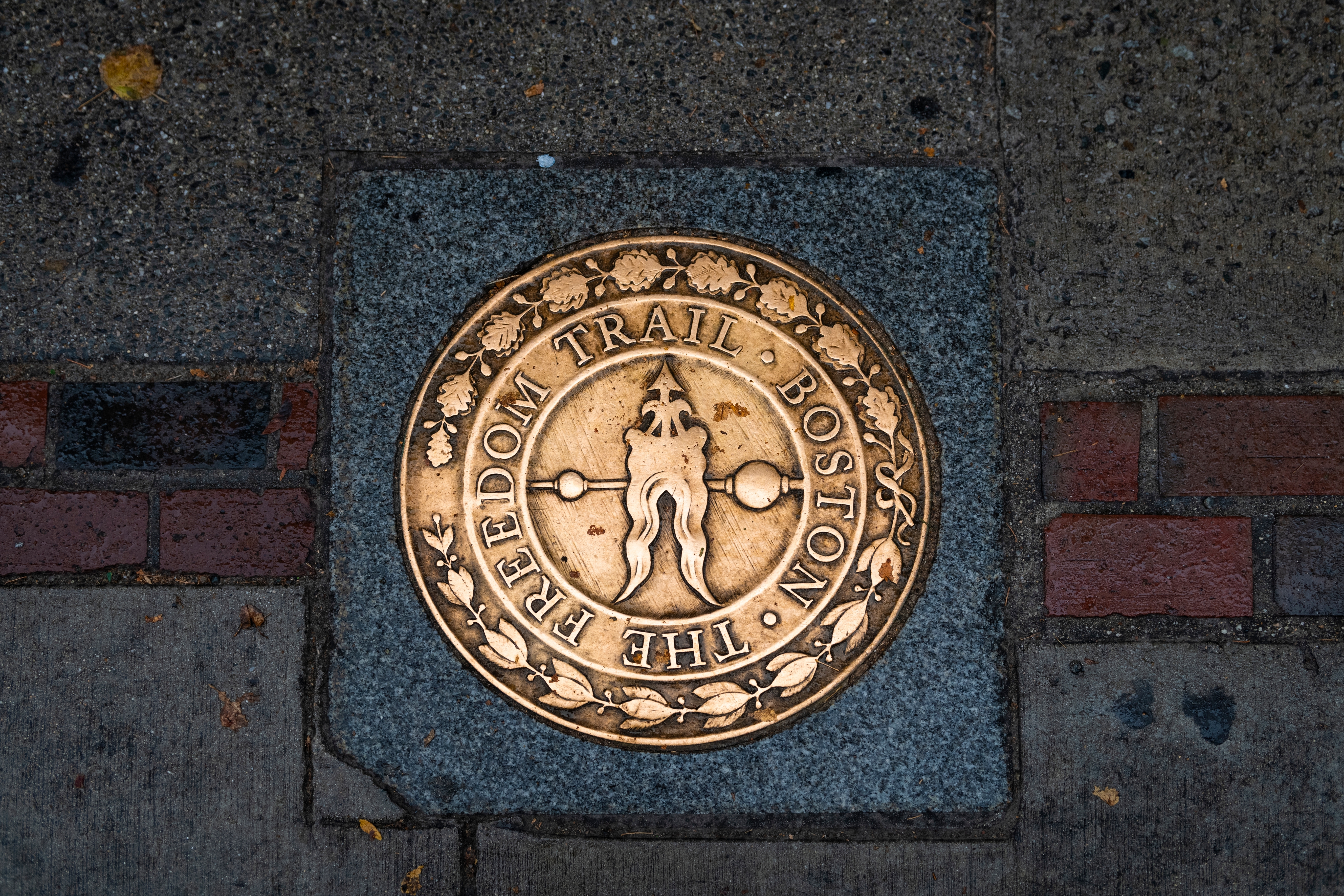 Shutterstock 2479620745 Boston, Massachusetts, USA October 29, 2023 View Of Freedom Trail Sign In A Sidewalk In The Downtown Of The City Of Boston, Massachusetts.