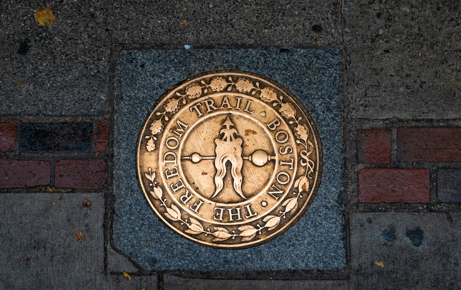 Shutterstock 2479620745 Boston, Massachusetts, USA October 29, 2023 View Of Freedom Trail Sign In A Sidewalk In The Downtown Of The City Of Boston, Massachusetts.