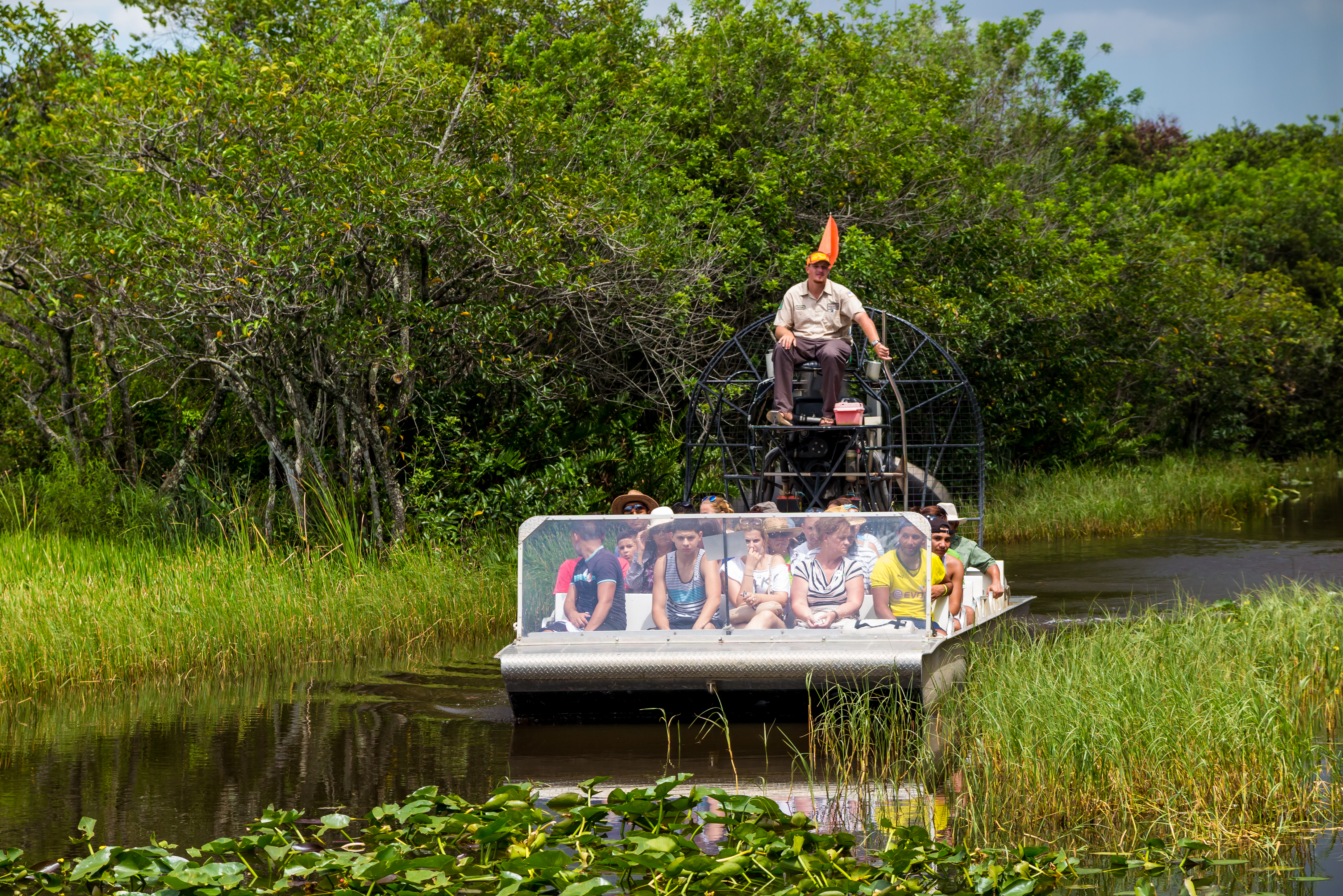 Shutterstock 210652315 EVERGLADES, UNITED STATES August 10, 2014 Group Of Tourists Riding An Airboat.