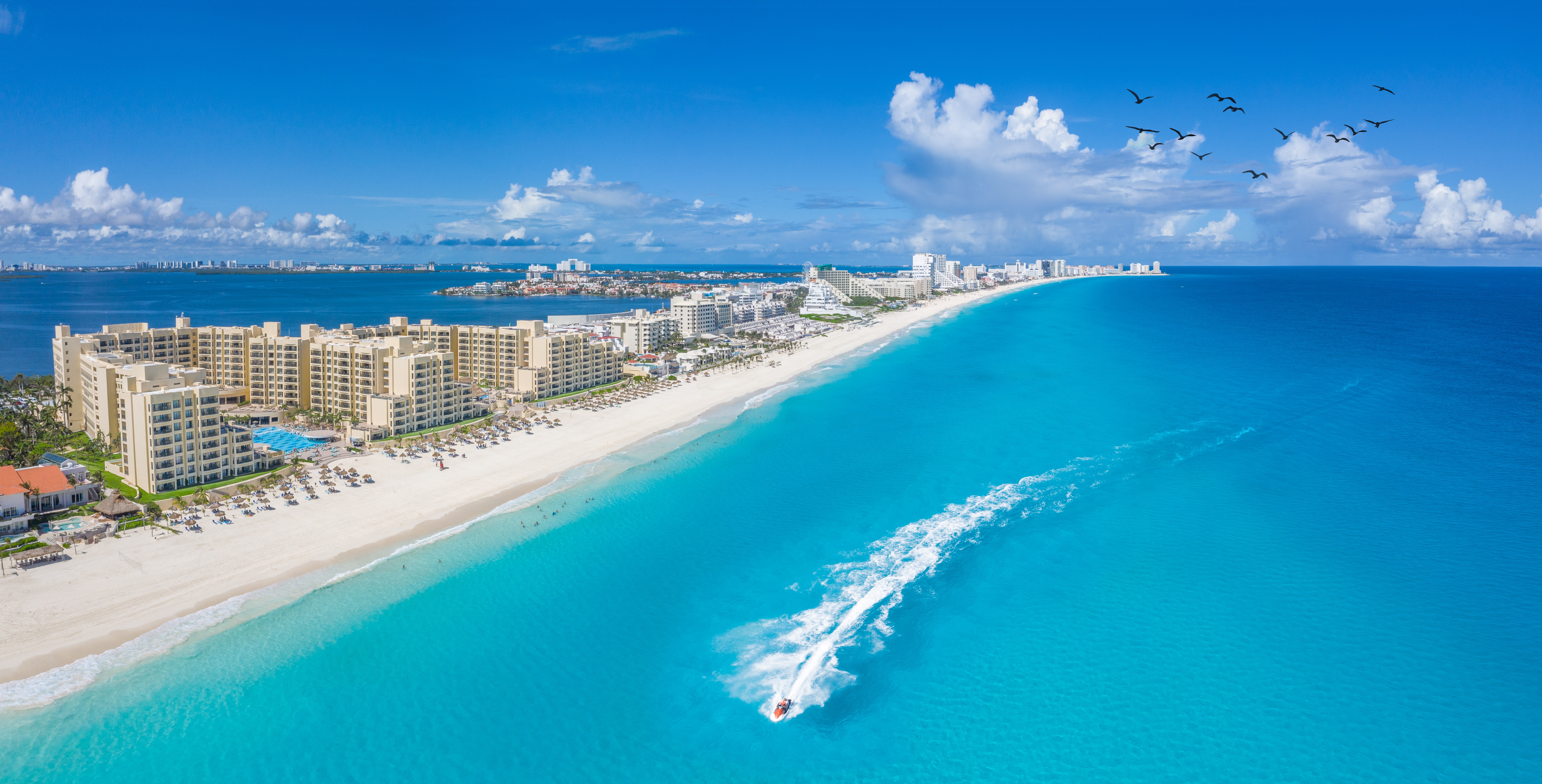 Shutterstock 2091829990 Cancun Beach With Boats And White Clouds