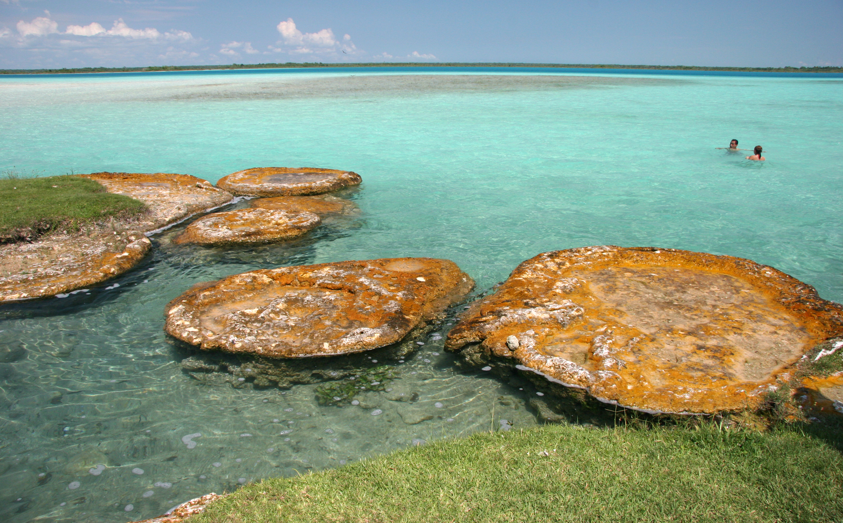 Shutterstock 12528193 Interesting Limestone Formations With Two Swimmers In A Shallow And Brilliant Blue Color Water. Laguna Bacalar. Yucatan. Mexico