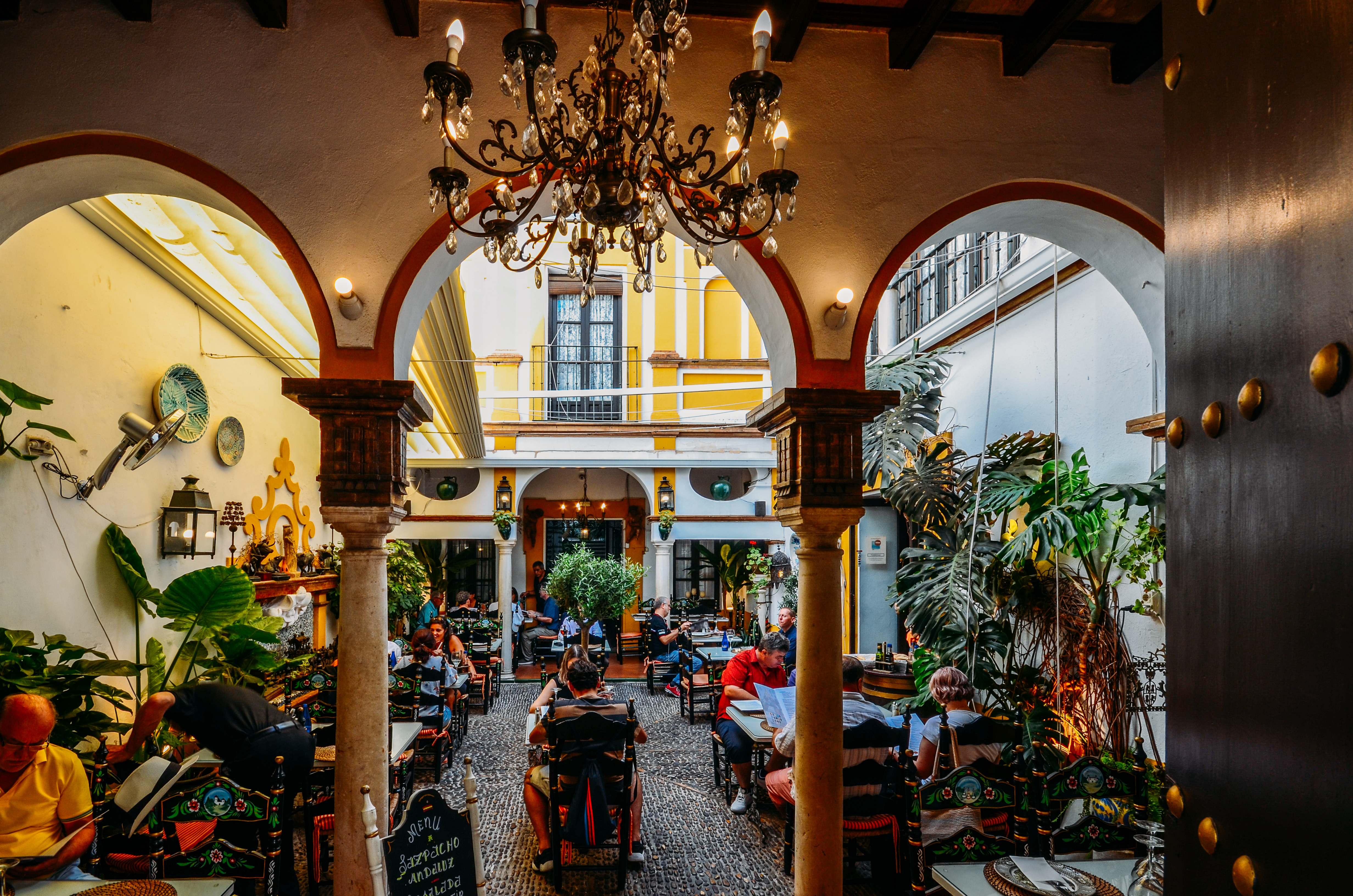 Busy Restaurant Courtyard In Sevilla, Spain With Traditional Moorish Arches Shutterstock 1508657483